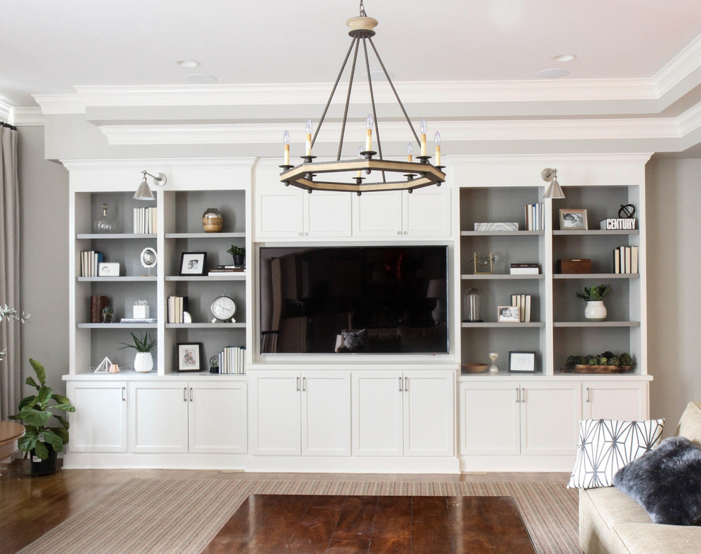 Inspiration for a large transitional open concept living room in Chicago with grey walls, medium hardwood floors, no fireplace, a built-in media wall and brown floor.