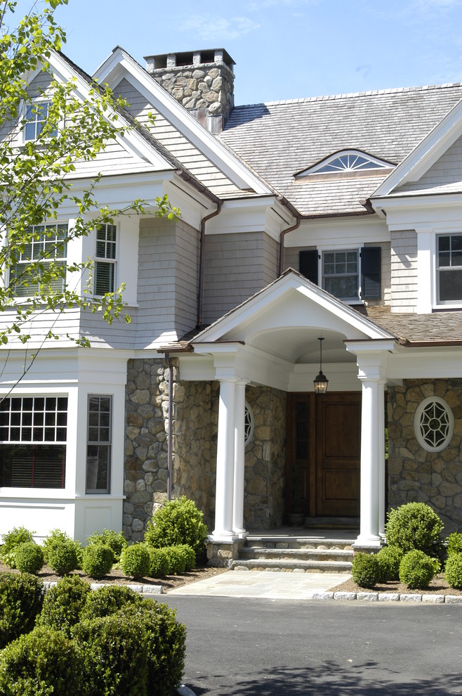 Photo of a traditional exterior in New York with stone veneer.