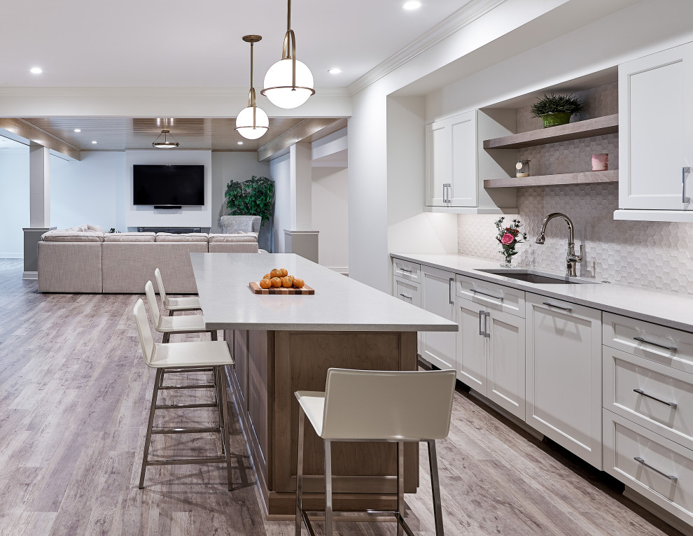 Large transitional walk-out gray floor basement photo in Charlotte with white walls and a hanging fireplace