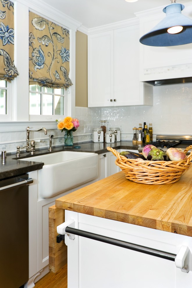 Traditional kitchen in San Francisco with a farmhouse sink, recessed-panel cabinets, white cabinets and white splashback.