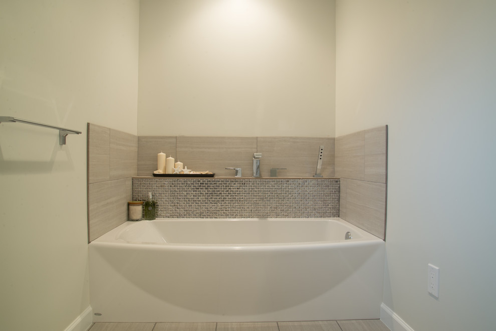 Mid-sized modern master bathroom in Seattle with an integrated sink, flat-panel cabinets, dark wood cabinets, solid surface benchtops, an alcove tub, an alcove shower, a two-piece toilet, gray tile, porcelain tile, beige walls and porcelain floors.