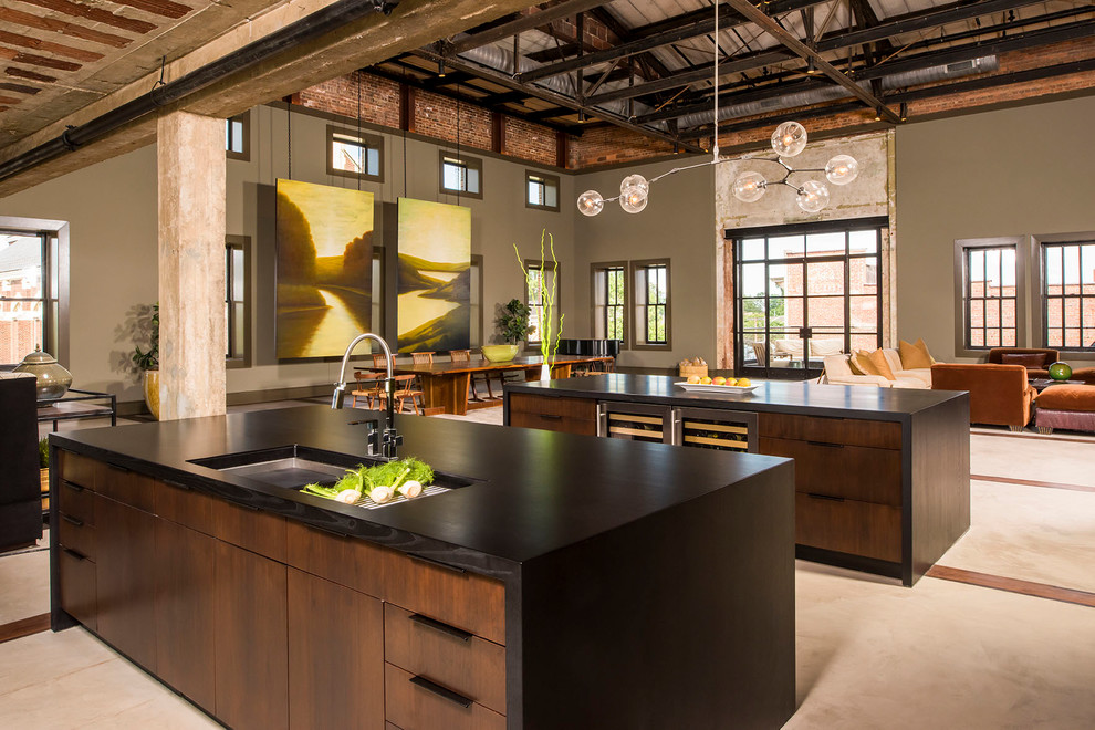 Inspiration for a large industrial open plan kitchen in Raleigh with an undermount sink, flat-panel cabinets, dark wood cabinets, granite benchtops, concrete floors, multiple islands and beige floor.