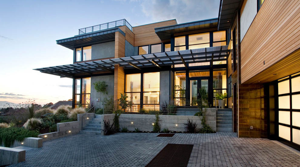 Photo of an expansive contemporary three-storey grey exterior in Toronto with wood siding and a flat roof.