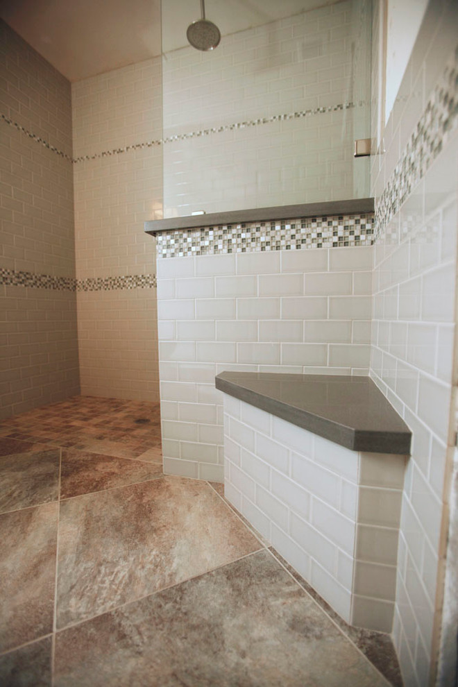 Inspiration for a mid-sized transitional 3/4 bathroom in Los Angeles with an open shower, a two-piece toilet, gray tile, subway tile, white walls, porcelain floors, a wall-mount sink, engineered quartz benchtops, brown floor and an open shower.