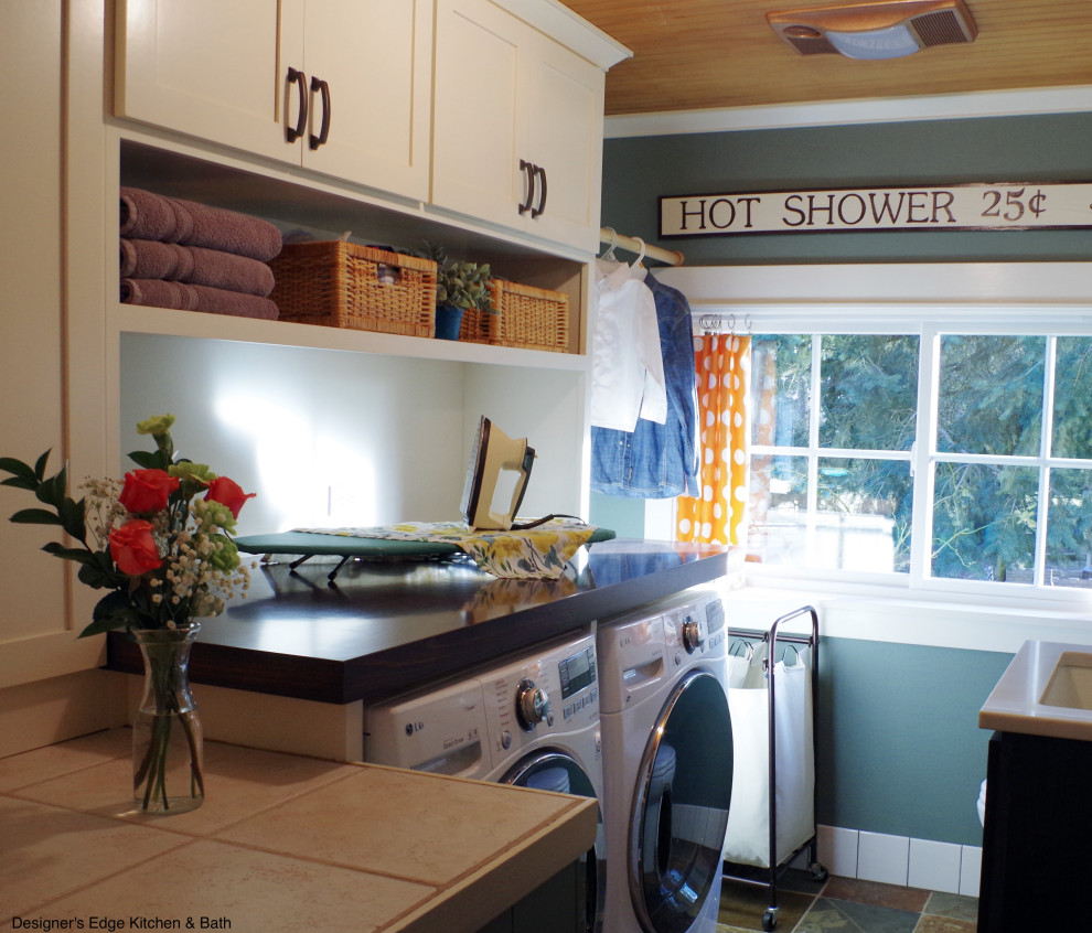 Inspiration for a small arts and crafts single-wall utility room in Portland with a single-bowl sink, shaker cabinets, white cabinets, wood benchtops, green walls, slate floors, a side-by-side washer and dryer, brown benchtop and wood.
