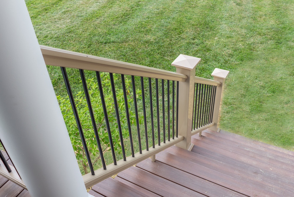 Deck - large transitional backyard deck idea in Baltimore with a fire pit and a roof extension