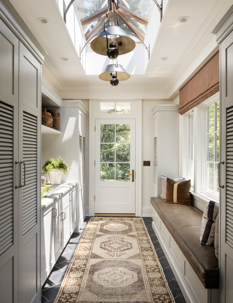 Inspiration for a traditional mudroom in New York with beige walls, a single front door, a white front door and black floor.