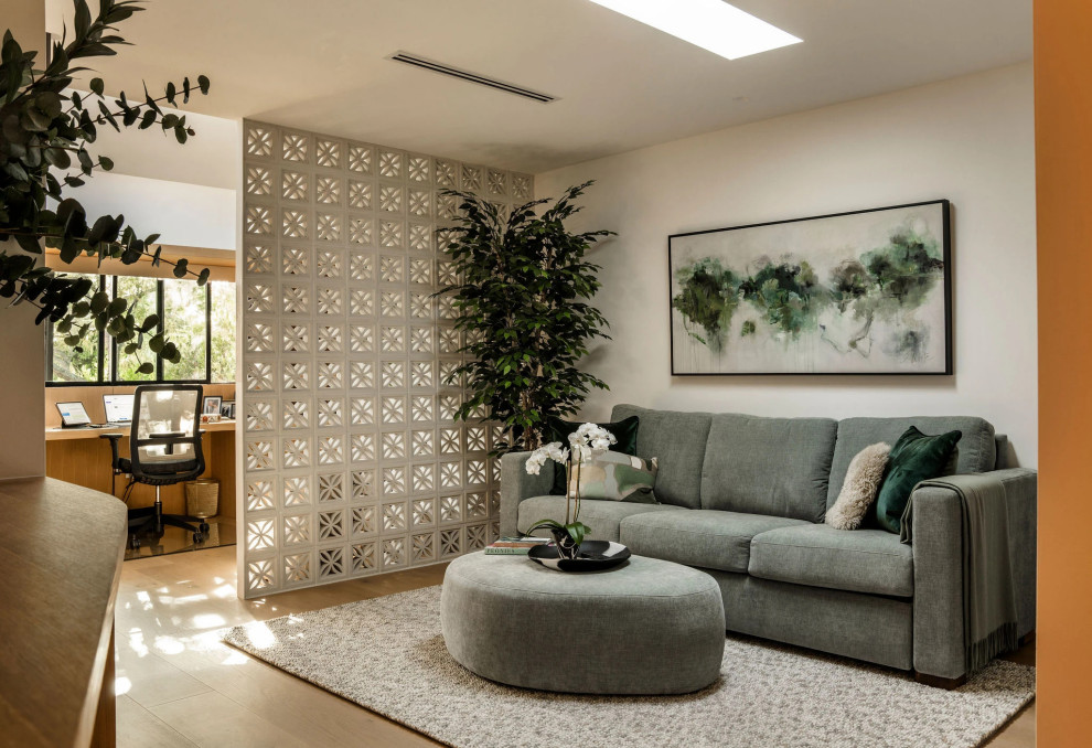 Example of a mid-century modern light wood floor and beige floor living room design in Los Angeles with white walls
