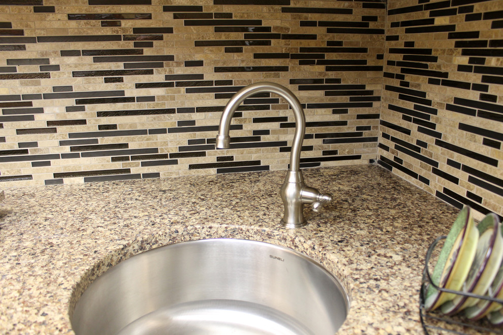 Small kitchen photo in New York with brown backsplash and stone tile backsplash