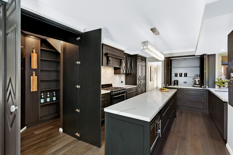 Midcentury galley open plan kitchen in Central Coast with a single-bowl sink, glass-front cabinets, dark wood cabinets, quartzite benchtops, white splashback, stone slab splashback, black appliances, vinyl floors and with island.