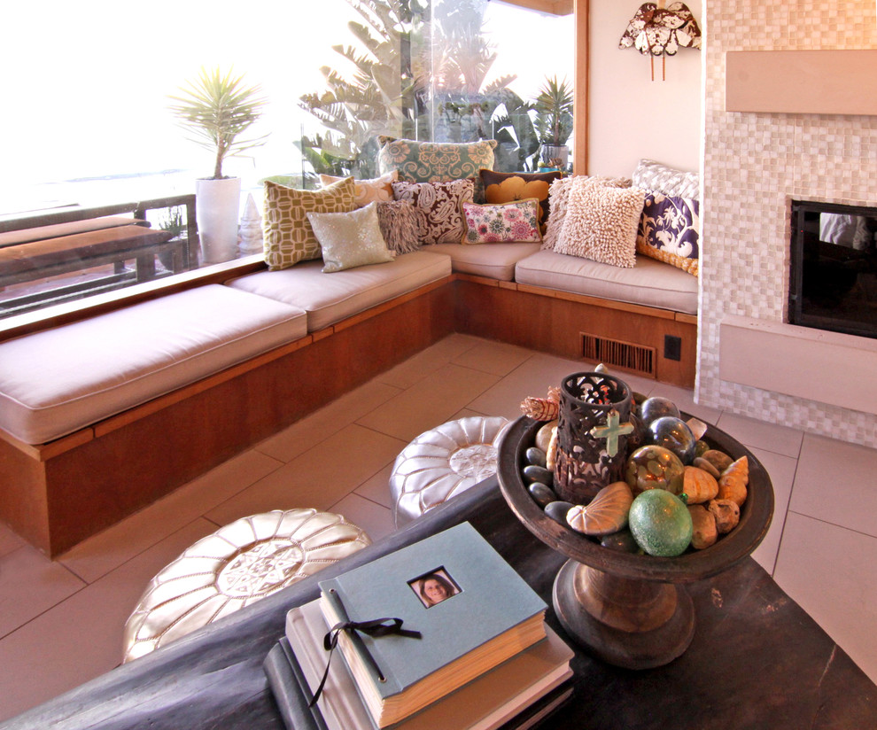 Inspiration for an eclectic family room in San Diego with a tile fireplace surround.