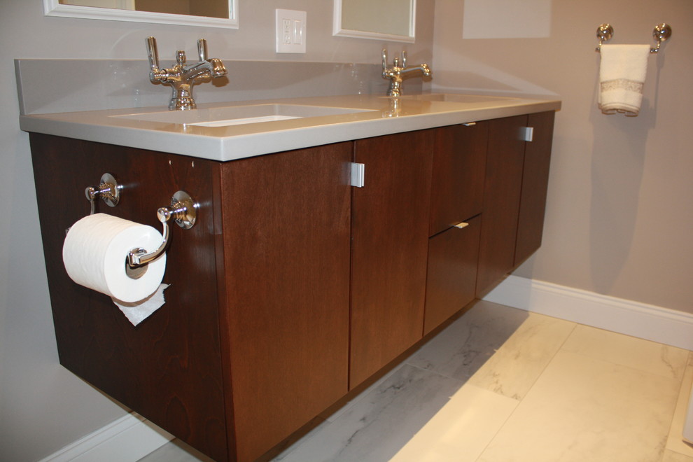 This is an example of a small modern master bathroom in Boston with flat-panel cabinets, brown cabinets, grey walls, an undermount sink, solid surface benchtops, marble floors and grey floor.