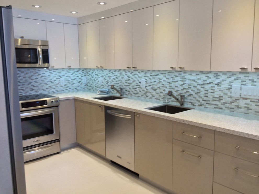 Design ideas for a mid-sized modern u-shaped kitchen pantry in Miami with an undermount sink, flat-panel cabinets, white cabinets, recycled glass benchtops, stainless steel appliances, porcelain floors, grey splashback, glass tile splashback and a peninsula.