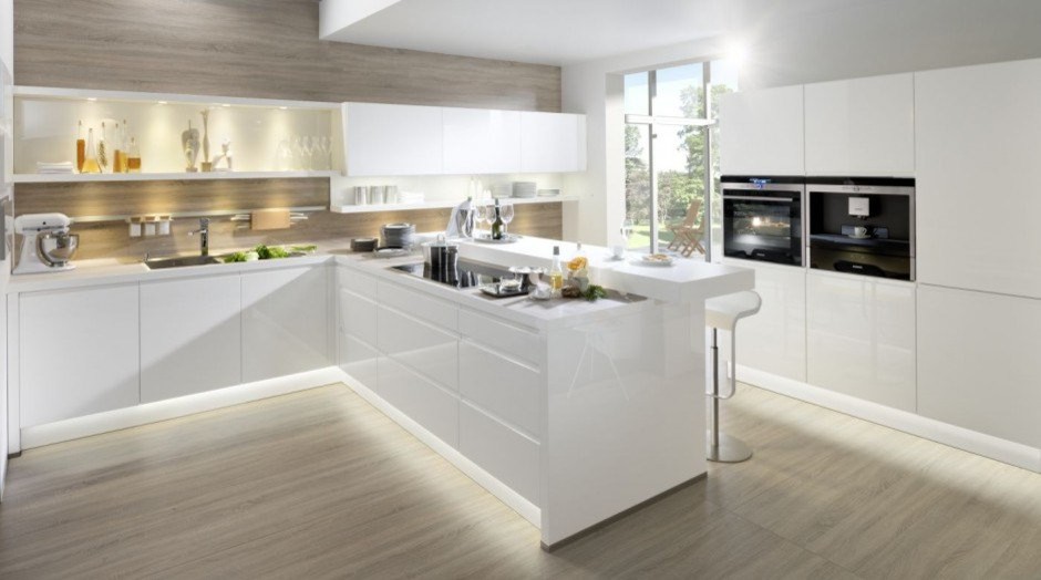 Photo of a large modern l-shaped eat-in kitchen in Other with an undermount sink, flat-panel cabinets, white cabinets, stainless steel appliances, medium hardwood floors, a peninsula and grey floor.