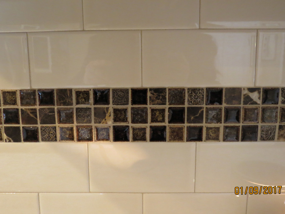 Mid-sized transitional l-shaped ceramic tile eat-in kitchen photo with an undermount sink, raised-panel cabinets, distressed cabinets, granite countertops, white backsplash, porcelain backsplash, stainless steel appliances and an island