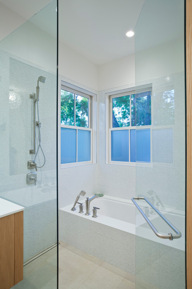 Inspiration for a mid-sized country master bathroom in Austin with an undermount sink, flat-panel cabinets, medium wood cabinets, engineered quartz benchtops, an alcove tub, an open shower, a one-piece toilet, white tile, ceramic tile, limestone floors, white walls, beige floor and a hinged shower door.