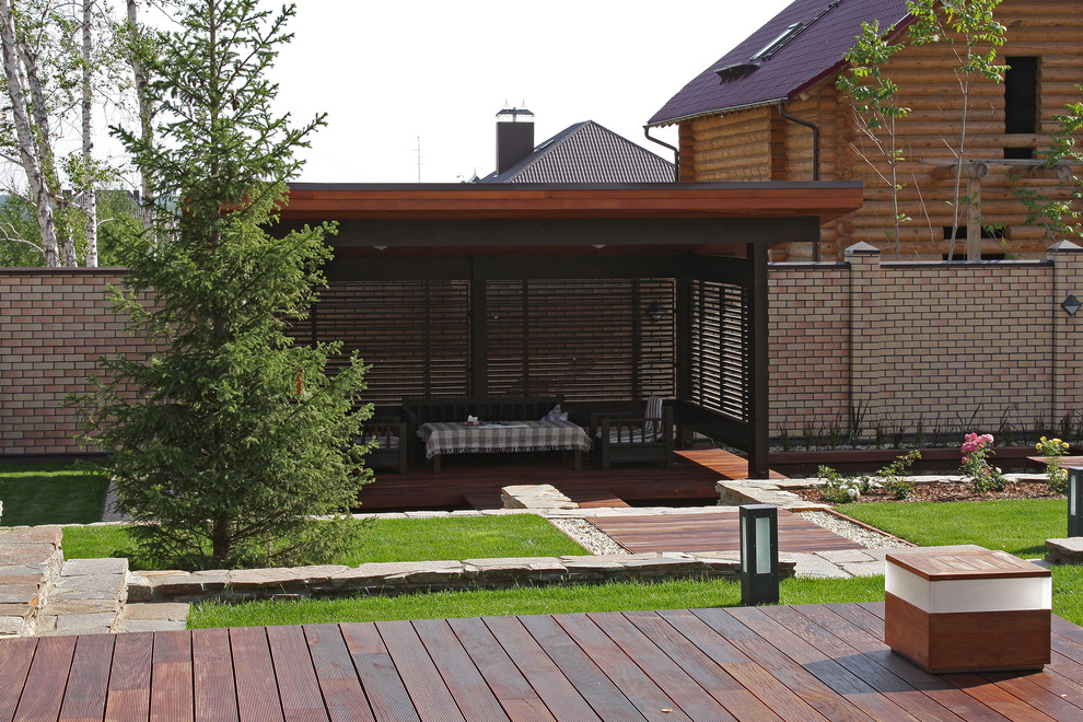 Photo of a scandinavian courtyard patio in Other with a gazebo/cabana.