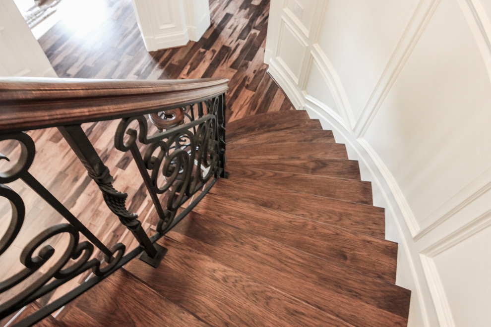 Inspiration for a large eclectic wood curved staircase in DC Metro with wood risers and mixed railing.