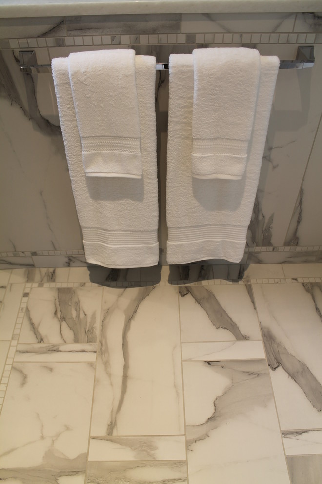 Walk-in shower - large transitional master porcelain tile porcelain tile and white floor walk-in shower idea in St Louis with shaker cabinets, blue cabinets, white walls, an undermount sink and solid surface countertops