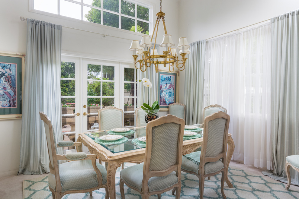 This is an example of a transitional dining room in Los Angeles with white walls.