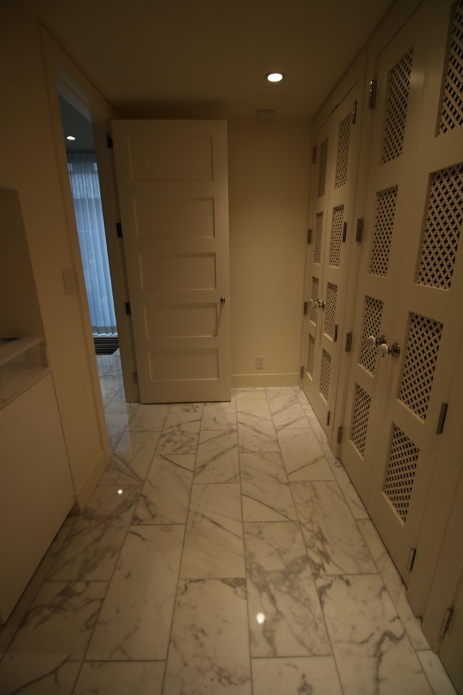 Modern laundry room in Vancouver with marble floors.
