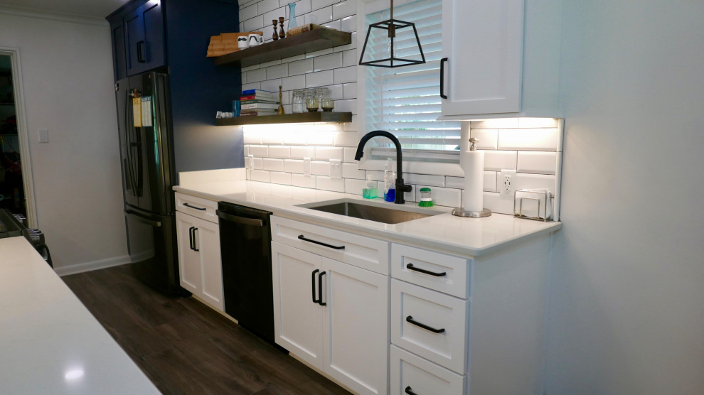 Mid-sized transitional galley porcelain tile and gray floor eat-in kitchen photo with an undermount sink, shaker cabinets, white cabinets, quartz countertops, white backsplash, subway tile backsplash, black appliances, no island and white countertops