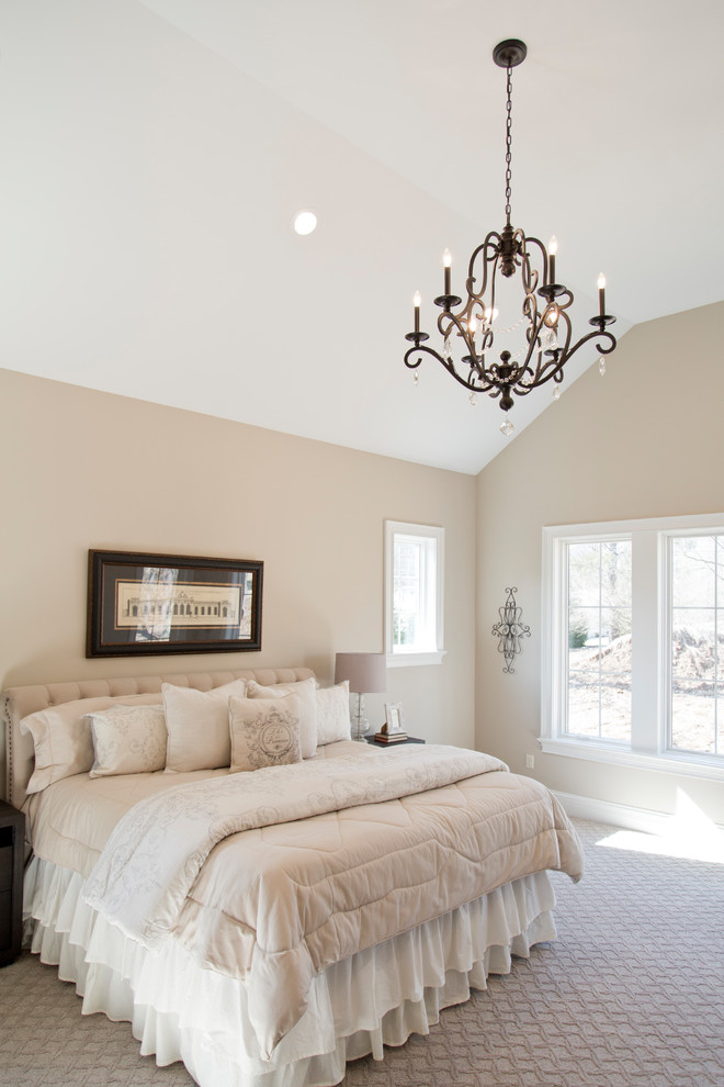 This is an example of a large country master bedroom in St Louis with beige walls, carpet and beige floor.