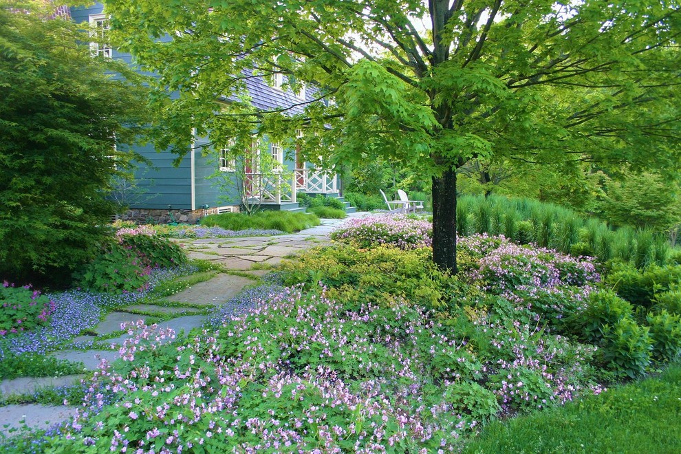 Photo of a mid-sized front yard partial sun garden for spring in Philadelphia with a garden path and natural stone pavers.