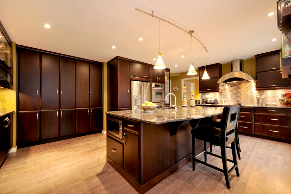 Kitchen - transitional dark wood floor kitchen idea in Toronto with a double-bowl sink, flat-panel cabinets, dark wood cabinets, granite countertops, mirror backsplash, stainless steel appliances and an island