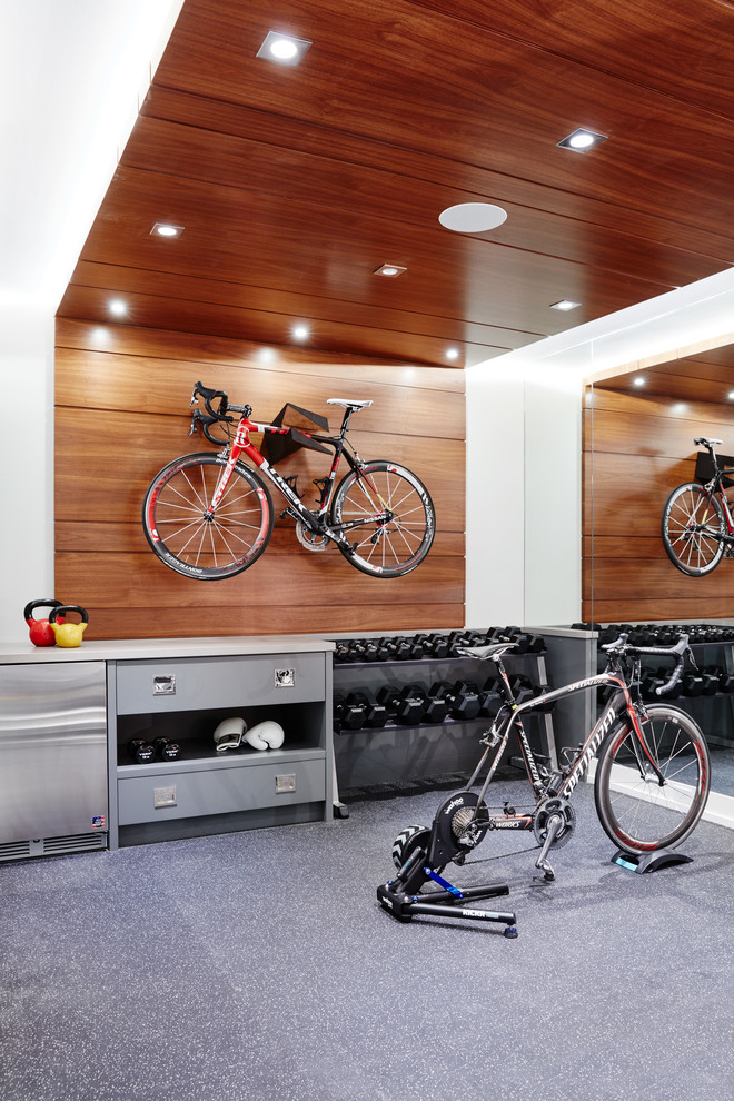 Transitional multipurpose gym in Toronto with white walls and grey floor.