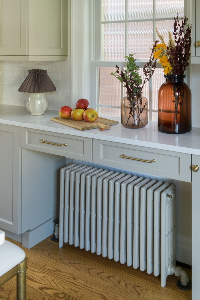 Example of a mid-sized transitional eat-in kitchen design in Chicago with recessed-panel cabinets, beige cabinets, quartz countertops, white backsplash, subway tile backsplash, an island and white countertops