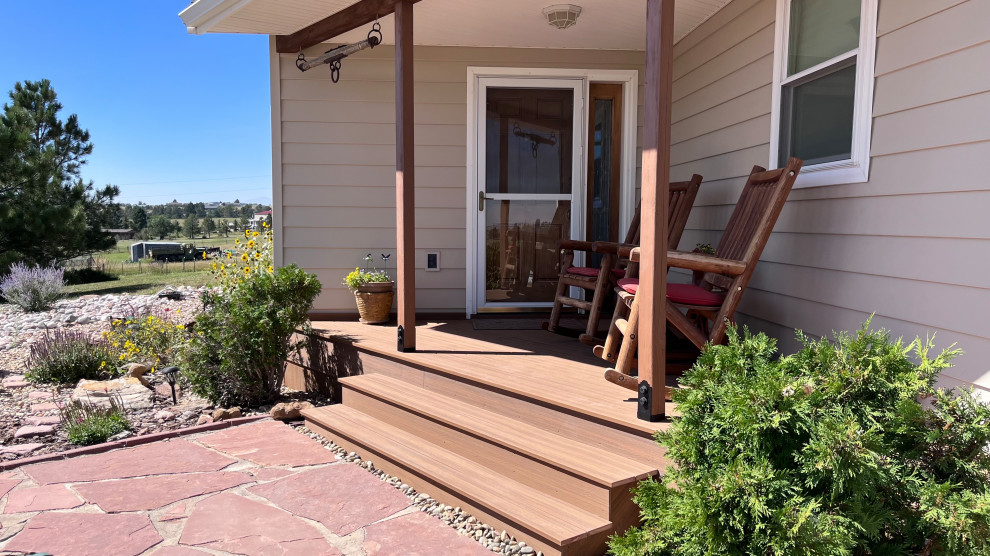 Inspiration for a front yard verandah in Other with decking and a roof extension.