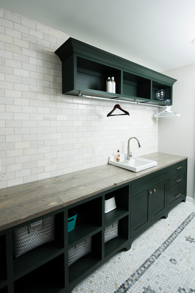 Mid-sized traditional galley dedicated laundry room in Indianapolis with a drop-in sink, shaker cabinets, green cabinets, wood benchtops, green walls, marble floors, a side-by-side washer and dryer and white floor.