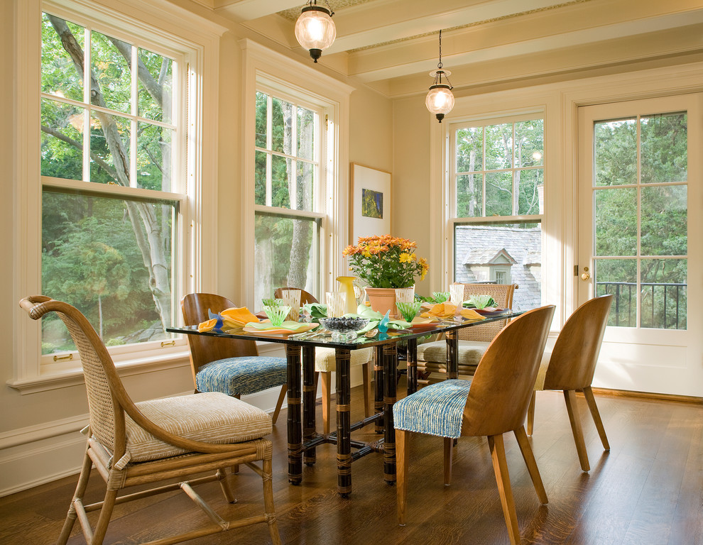 This is an example of a mid-sized traditional dining room in New York with beige walls, dark hardwood floors and brown floor.