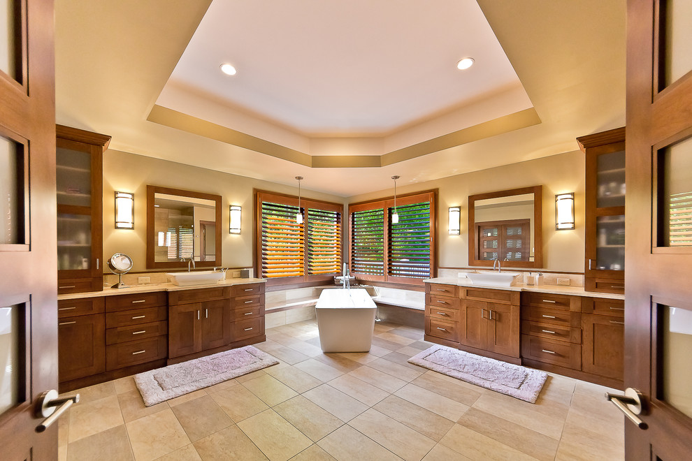 Design ideas for a large traditional master bathroom in DC Metro with a vessel sink, shaker cabinets, medium wood cabinets, granite benchtops, a freestanding tub, a corner shower, a one-piece toilet, beige tile, porcelain tile, yellow walls and porcelain floors.