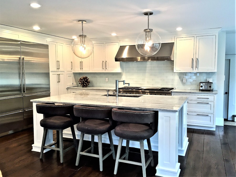 Example of a transitional l-shaped eat-in kitchen design in New York with shaker cabinets, white cabinets, quartz countertops, stainless steel appliances and an island