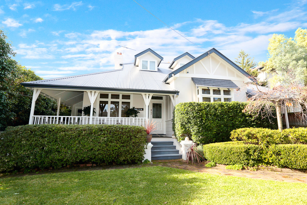 This is an example of a mid-sized traditional two-storey brick beige exterior in Sydney with a gable roof.