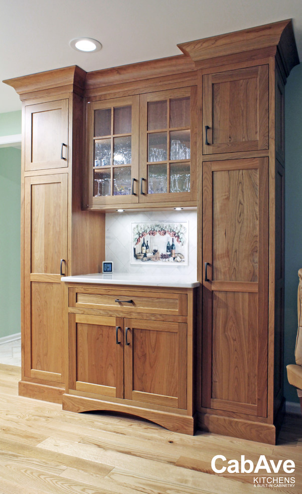 Large transitional u-shaped light wood floor and beige floor open concept kitchen photo with an undermount sink, recessed-panel cabinets, light wood cabinets, quartz countertops, green backsplash, mosaic tile backsplash, stainless steel appliances and a peninsula