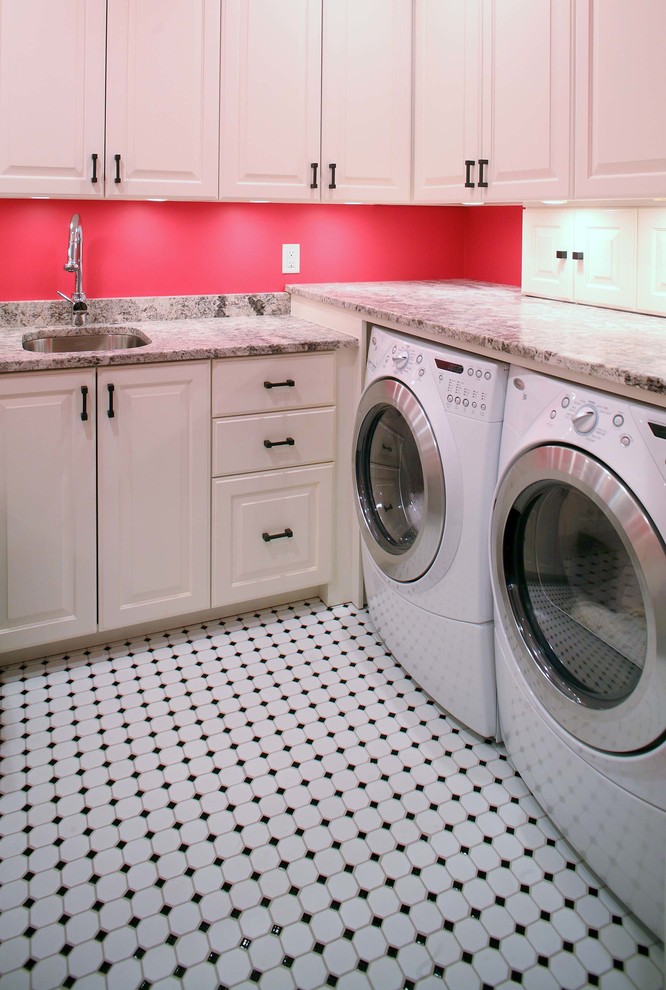 Inspiration for a mid-sized traditional u-shaped utility room in Raleigh with an undermount sink, recessed-panel cabinets, white cabinets, granite benchtops, red walls, ceramic floors and a side-by-side washer and dryer.