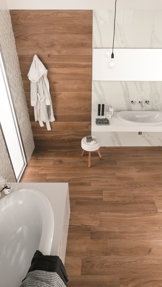 Inspiration for a contemporary bathroom in Perth with a freestanding tub, brown tile, porcelain tile, brown walls, porcelain floors, solid surface benchtops and a drop-in sink.