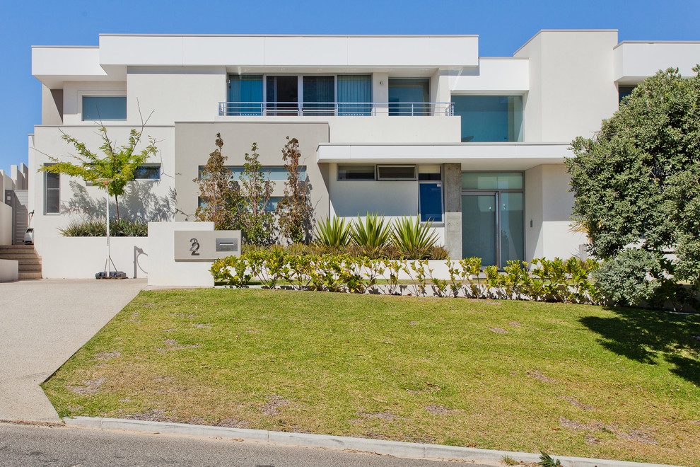 Photo of a contemporary stucco exterior in Perth.