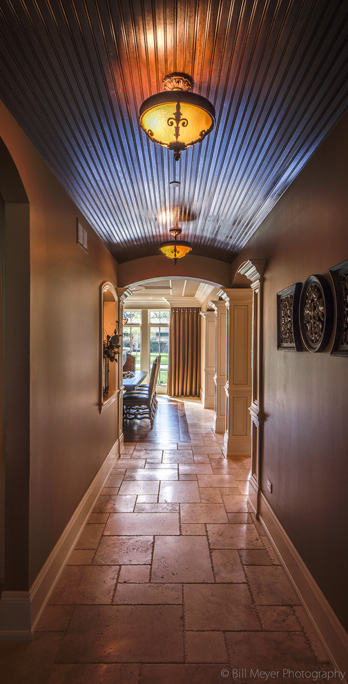 This is an example of a traditional hallway in Chicago with travertine floors.