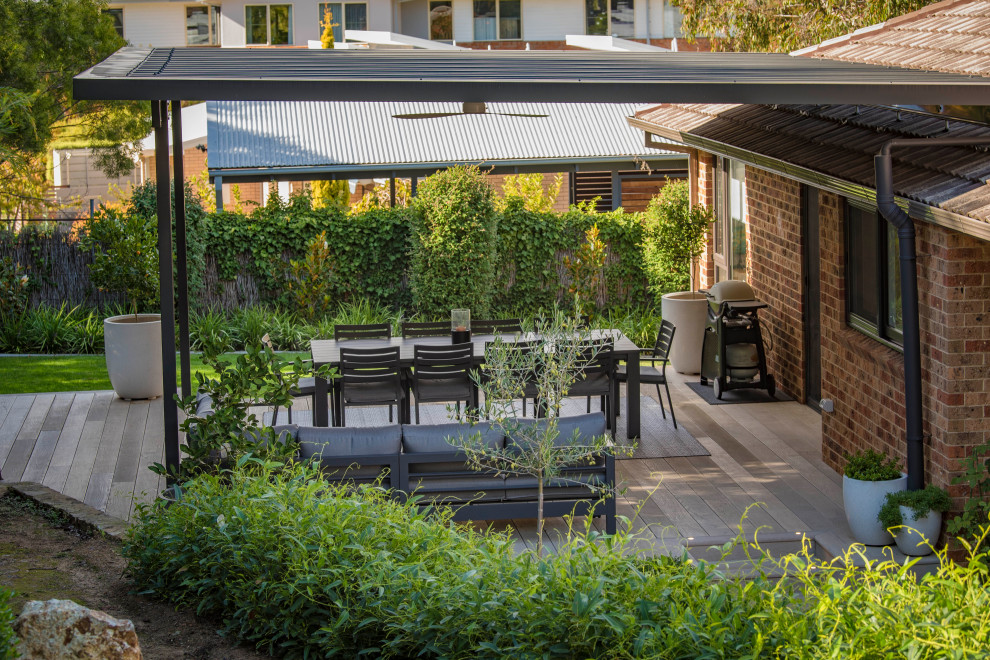 Inspiration for a large contemporary backyard and ground level deck in Canberra - Queanbeyan with a pergola.