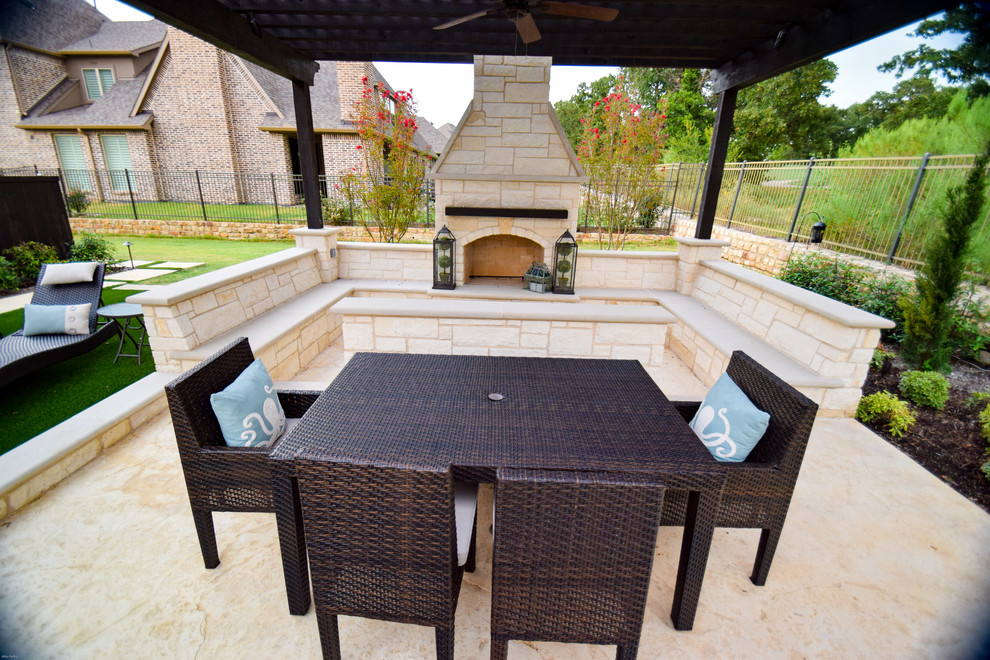 Photo of a mid-sized contemporary backyard patio in Dallas with a water feature and natural stone pavers.