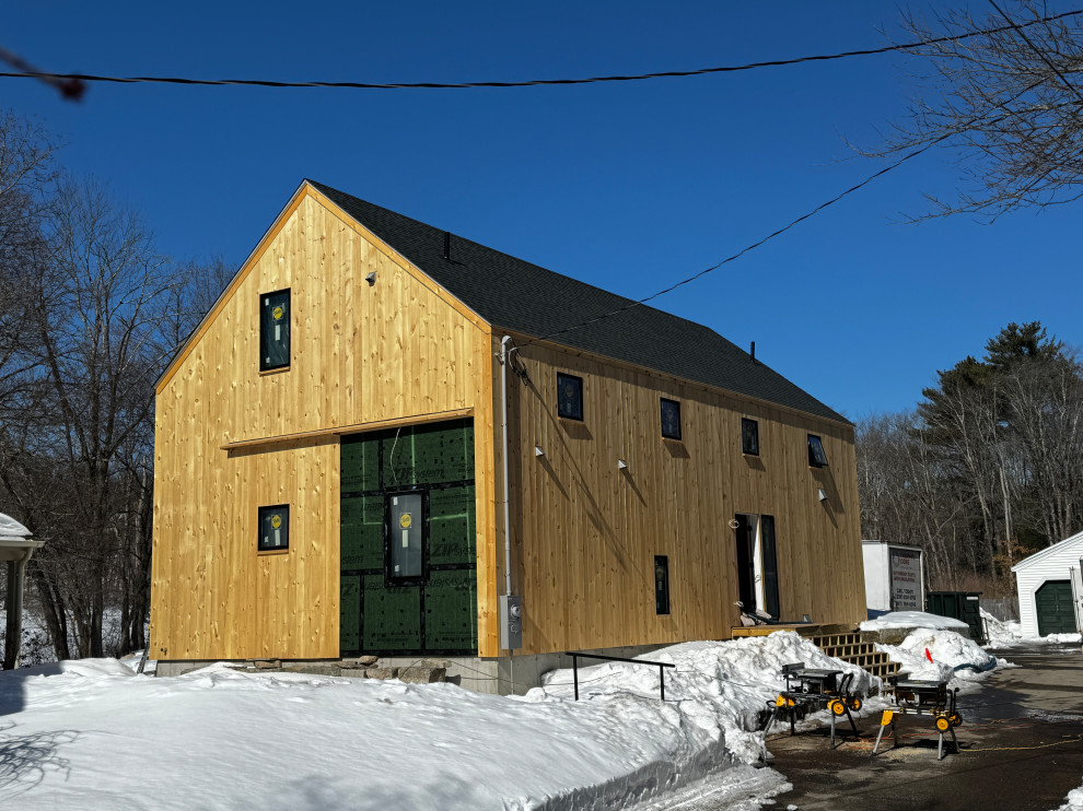 Example of a farmhouse home design design in Boston