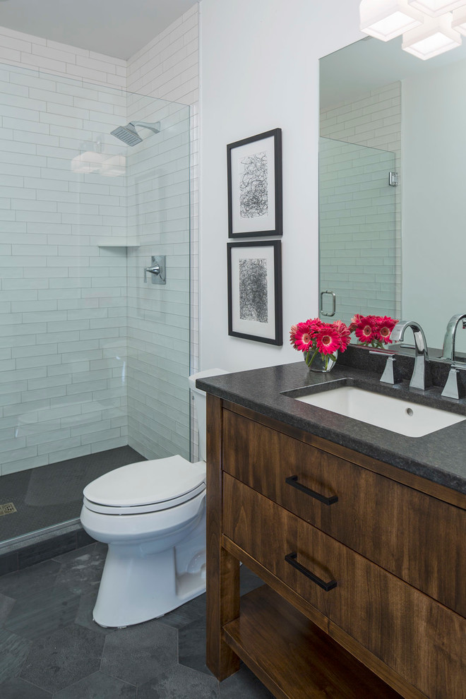 Contemporary bathroom in Minneapolis with furniture-like cabinets, dark wood cabinets, an alcove shower, a two-piece toilet, white tile, subway tile, white walls and granite benchtops.