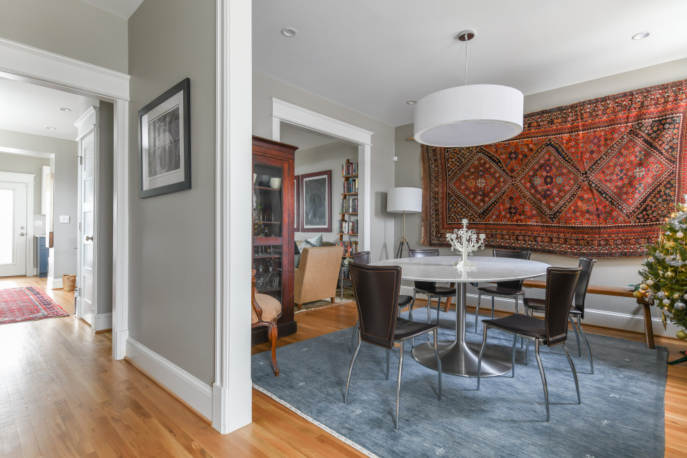 Photo of a medium sized classic dining room with grey walls and medium hardwood flooring.