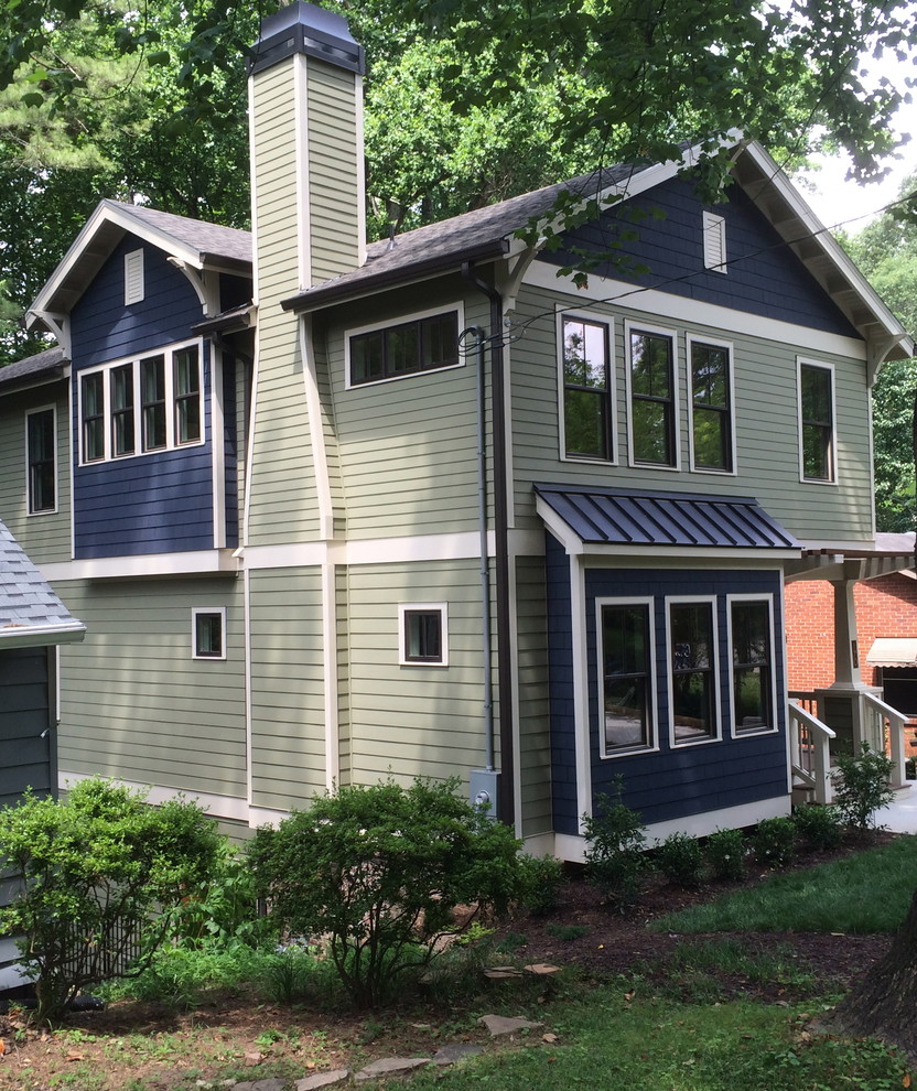 Photo of a mid-sized arts and crafts three-storey green exterior in Atlanta with concrete fiberboard siding and a gable roof.