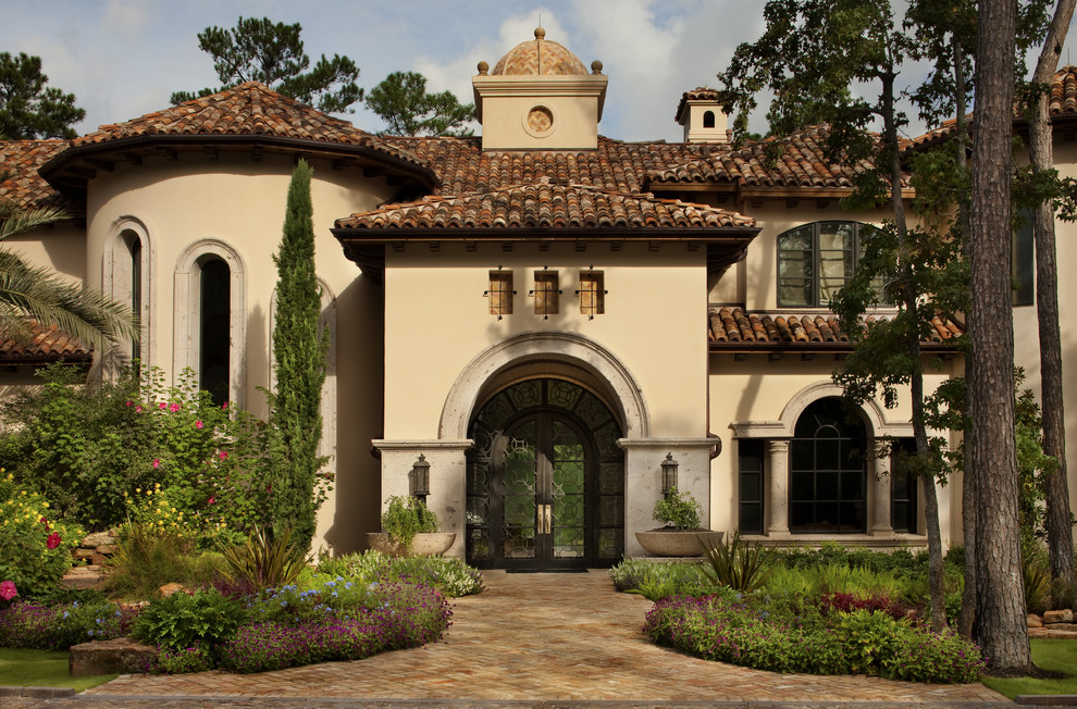 Mediterranean stucco exterior in Austin with a tile roof.
