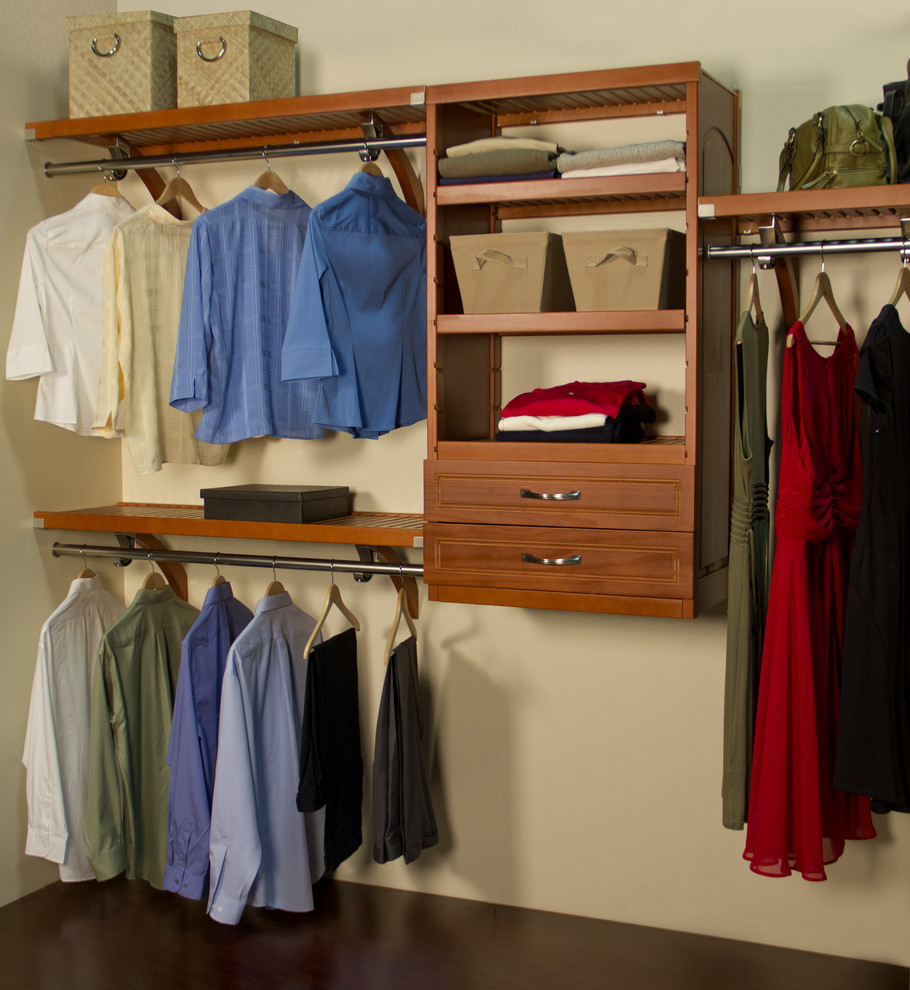Photo of a mid-sized arts and crafts gender-neutral walk-in wardrobe in Jacksonville with raised-panel cabinets and medium wood cabinets.